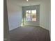 Carpeted bedroom featuring ample natural light from a well-sized window at 71 Furley St, Homesite 116, Sanford, NC 27330