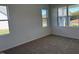 Bright bedroom featuring plush carpet, neutral walls, and plenty of natural light from the multiple windows at 71 Furley St, Homesite 116, Sanford, NC 27330