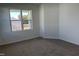 Bedroom offering a bright interior due to a well-placed window, complemented by neutral walls and carpeting at 71 Furley St, Homesite 116, Sanford, NC 27330