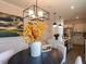 Bright dining area featuring a modern light fixture, a table, and an open view into the kitchen at 71 Furley St, Homesite 116, Sanford, NC 27330