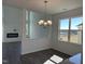 Charming dining area with stylish chandelier, modern floors, and ample natural light from the large window at 71 Furley St, Homesite 116, Sanford, NC 27330