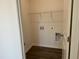 Practical laundry room with washer/dryer hookups and upper shelving providing efficient space for laundry needs at 71 Furley St, Homesite 116, Sanford, NC 27330