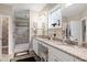 Bright bathroom featuring a double sink vanity, granite countertops, and large walk-in shower at 80 Thornwhistle Pl, Garner, NC 27529