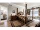 Luxurious bedroom featuring a four-poster bed, hardwood floors, and elegant decor at 80 Thornwhistle Pl, Garner, NC 27529