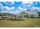 Community clubhouse with a covered porch, gas grills, landscaping, and outdoor seating at 80 Thornwhistle Pl, Garner, NC 27529