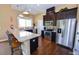 Modern kitchen with granite countertops, stainless steel appliances, and dark wood cabinetry at 80 Thornwhistle Pl, Garner, NC 27529
