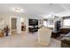 Spacious living room featuring neutral carpet, media center, and entertainment area with a barbershop room and bathroom off to the side at 80 Thornwhistle Pl, Garner, NC 27529