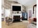 Well-decorated living room featuring a fireplace, hardwood floors, and elegant furnishings at 80 Thornwhistle Pl, Garner, NC 27529