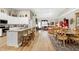 Bright and airy living space featuring hardwood floors, tall ceilings, and a seamless flow from kitchen to living area at 80 Thornwhistle Pl, Garner, NC 27529