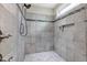 Large walk-in shower features neutral tile surround with a decorative accent stripe and a shower niche at 80 Thornwhistle Pl, Garner, NC 27529
