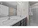 Bright bathroom featuring a double vanity with white countertops and modern fixtures plus shower with glass doors at 801 Pryor St # 48, Mebane, NC 27302