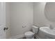 Cozy half bathroom featuring a pedestal sink and white toilet, complemented by light paint at 801 Pryor St # 48, Mebane, NC 27302