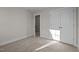 Bedroom with neutral walls, carpet, and closet with double doors and open door leading to other rooms at 801 Pryor St # 48, Mebane, NC 27302