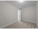 Bright bedroom offers neutral walls, carpet, a recessed light, and a open door leading to other rooms at 801 Pryor St # 48, Mebane, NC 27302