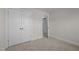 Bedroom featuring double door closet, neutral walls and carpet, plus view of open door leading to other rooms at 801 Pryor St # 48, Mebane, NC 27302