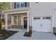 Charming front door with stone accents and a single-car garage offers inviting curb appeal at 801 Pryor St # 48, Mebane, NC 27302