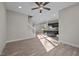 Open-concept living area with hardwood floors, a staircase, and a view of the modern kitchen at 801 Pryor St # 48, Mebane, NC 27302