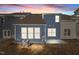 Rear exterior showcasing a home's blue siding, multiple windows, and air conditioning unit at 803 Pryor St # 47, Mebane, NC 27302
