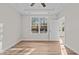 Bright bedroom featuring a ceiling fan, tray ceiling, and large windows for natural light at 803 Pryor St # 47, Mebane, NC 27302