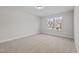 Bright, carpeted bedroom featuring neutral walls and a large window, offering ample natural light at 803 Pryor St # 47, Mebane, NC 27302