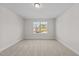 Cozy bedroom featuring neutral walls, plush carpeting, and a bright window offering a peaceful ambiance at 803 Pryor St # 47, Mebane, NC 27302