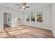 Well-lit bedroom featuring wood floors and ample natural light from the three large windows at 803 Pryor St # 47, Mebane, NC 27302