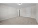 Neutrally painted bedroom featuring plush carpeting, white trim, and two doors for access and privacy at 803 Pryor St # 47, Mebane, NC 27302