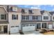 Charming townhome exterior with a two-car garage, light blue siding, and dark shutters at 803 Pryor St # 47, Mebane, NC 27302