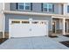 Close-up of a two-car garage exterior featuring carriage doors and stone accents at 803 Pryor St # 47, Mebane, NC 27302