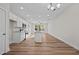 Bright, open kitchen with white cabinets, an island, stainless appliances, and wood floors at 803 Pryor St # 47, Mebane, NC 27302