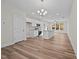 Spacious kitchen with white cabinetry, island, stainless steel appliances, and hardwood flooring at 803 Pryor St # 47, Mebane, NC 27302