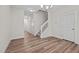 Open concept living room with hardwood style floors, stairway, and neutral color palette at 803 Pryor St # 47, Mebane, NC 27302