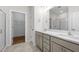 Modern bathroom features double vanity, light gray cabinets, quartz counters, tile floors and glass shower door at 807 Pryor St # 45, Mebane, NC 27302