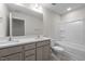 Bathroom featuring double sink vanity with quartz countertops, tile flooring, and tub/shower combination at 807 Pryor St # 45, Mebane, NC 27302