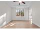 Bright bedroom features light wood floors, white walls, ceiling fan and a large window for natural light at 807 Pryor St # 45, Mebane, NC 27302