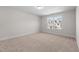 Bright bedroom with neutral carpet, fresh paint, and a large window at 807 Pryor St # 45, Mebane, NC 27302