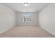 Bright bedroom with neutral carpet, fresh paint, and a large window at 807 Pryor St # 45, Mebane, NC 27302