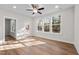 Bright bedroom features hardwood floors, a ceiling fan, and three large windows with natural views at 807 Pryor St # 45, Mebane, NC 27302