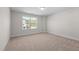 Carpeted bedroom with neutral paint and a large window for natural light at 807 Pryor St # 45, Mebane, NC 27302