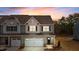 Charming two-story townhome featuring a one car garage and neutral siding with a meticulously maintained lawn at 807 Pryor St # 45, Mebane, NC 27302