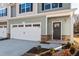 Stylish townhome facade with stone accents, attached garage, and a cozy entrance at 807 Pryor St # 45, Mebane, NC 27302