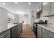 Modern kitchen featuring gray cabinets, granite countertops, stainless steel appliances, and hardwood floors at 807 Pryor St # 45, Mebane, NC 27302