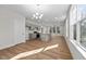 Bright open-concept kitchen and living area with modern gray cabinets, granite countertops, and new hardwood flooring at 807 Pryor St # 45, Mebane, NC 27302