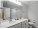 Bathroom features double sinks with a large mirror, white countertop, and grey tiled floor and toilet at 814 Silo Park Dr, Wake Forest, NC 27587