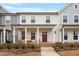 Inviting two-story townhome with a charming front porch and well-maintained landscaping at 814 Silo Park Dr, Wake Forest, NC 27587
