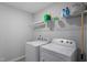 Functional laundry room with a washer, dryer, and shelving for storage and organization at 814 Silo Park Dr, Wake Forest, NC 27587
