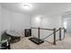 Bright loft area featuring a chair, bookshelf, and small treadmill, creating a versatile space at 814 Silo Park Dr, Wake Forest, NC 27587
