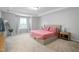 Spacious bedroom with a large window, tray ceiling, and neutral carpet for a comfortable retreat at 814 Silo Park Dr, Wake Forest, NC 27587