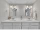 Bathroom features dual sinks and mirrors with modern lighting at 9321 Stephenson Adams Ln, Willow Springs, NC 27592
