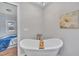 Bathroom features a claw foot tub with views into the primary bedroom at 9321 Stephenson Adams Ln, Willow Springs, NC 27592